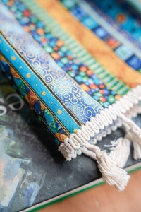 Close-up of bohemian striped printed fabric showing exquisite patterns and white tassels