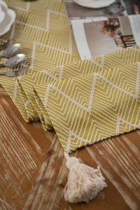 Macro shot of Nordic jacquard table runner showing geometric texture and cotton tassels