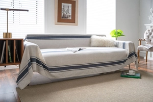 Detailed texture of navy blue striped sofa throw blanket in a minimalist home setting