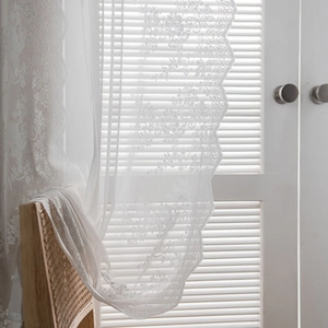 Elegant white lace curtains with vintage floral embroidery and scalloped edges for home decor