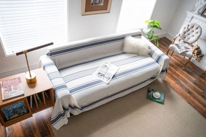 Detail view of navy blue striped sofa cover with durable cat-scratch resistant fabric