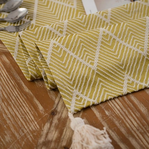 Modern Nordic table runner with yellow geometric wave patterns and cream tassels