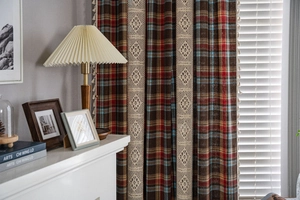 Detailed macro view of American plaid curtains with hollow crochet lace and tassel trim