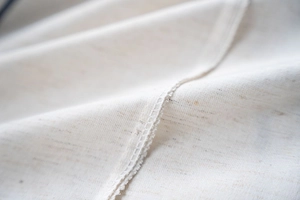 Detail of high-quality navy blue sofa cover fabric showing durable stitching and texture