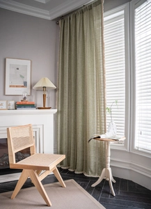 Detail of green rural curtain with vertical stripe embroidery and beige tassel trim fringe