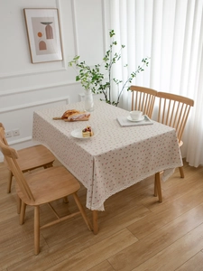Close-up of pink cherry print cotton linen tablecloth with delicate white lace border