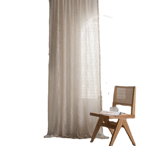 Rideau beige au crochet avec motifs géométriques ajourés et pompons pour le salon