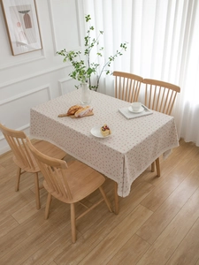 Detail of cherry print cotton linen tablecloth with delicate white lace border edge