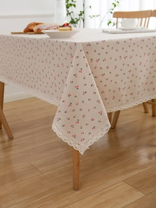 Close-up of pink cherry print cotton linen tablecloth with white crochet lace edges
