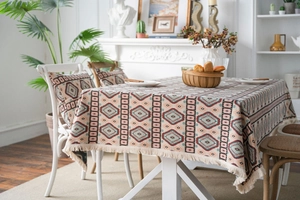 Detail of American jacquard tablecloth with geometric diamond patterns and fringe trim