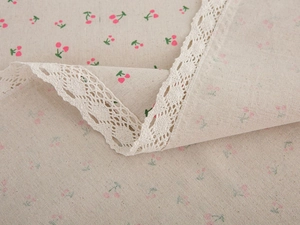 Detailed view of pastoral cotton linen tablecloth with cherry print and white lace trim