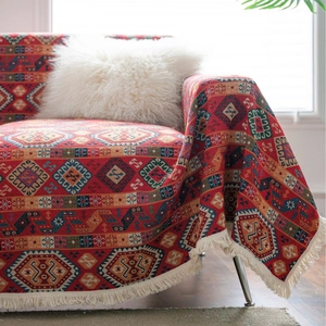 Ethnic geometric jacquard sofa cover in festive red with cream fringe tassels