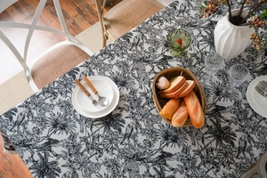 Detail of jacquard tablecloth with black leopard jungle print and delicate tassel edges