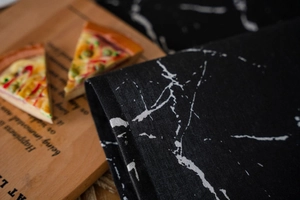 Detail of black and white marble pattern fabric texture on a dining table runner