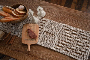 Detail of handmade bohemian cotton table runner with hollow geometric weaving patterns