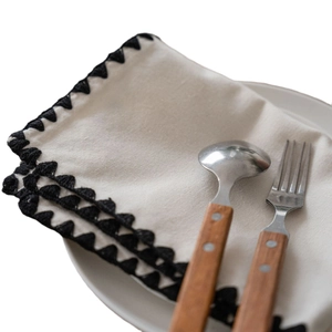 Minimalist beige embroidered table runner with delicate black crochet lace trim decoration