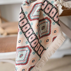 Bohemian geometric table runner with colorful diamond patterns and white tassel edges