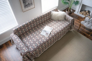 Close-up of bohemian geometric pattern and fringed edges on a heavy sofa cover