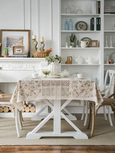Detail of floral dandelion print tablecloth with hollow crochet lace and scalloped edges