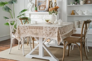 Detail of floral tablecloth featuring beige hollow lace splicing and rustic cotton linen texture