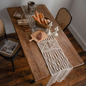 Bohemian hand-woven cotton table runner with geometric patterns and fringe decor