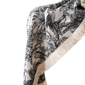 Black and white jacquard tablecloth with tropical palm trees and fringe detail