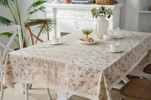 Detail of floral rectangular tablecloth with vintage lace patchwork and hollow edges