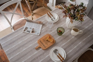 Macro detail of brown striped embroidery and hollow-out knot patterns on linen tablecloth