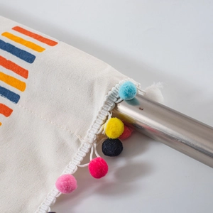Canvas cafe curtain with geometric colorful stripes and vibrant pom-pom trim for kitchen