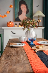 Handmade crochet Halloween table runner with orange and black hollow patterns