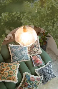 Close-up of jacquard cushion covers with intricate patterns and elegant tassel edges