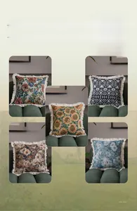 Detail of vintage jacquard throw pillows with floral patterns and cream tassel edges