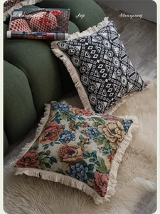 Detail of jacquard pillow covers with ethnic geometric patterns and stylish cream fringes