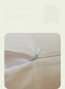 Detailed close-up of invisible zipper design and beige jacquard fabric on throw pillow