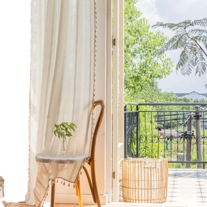 Elegant white striped lace curtains with tassel edges for a cozy living room decor