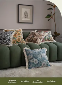 Detailed view of jacquard sofa cushions with sunflower patterns and fringe tassels