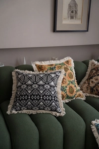 Detailed close-up of decorative jacquard pillow covers with stylish tassels and ethnic patterns
