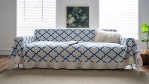 Detail of clover print sofa cover featuring elegant ruffled edges and cream fabric