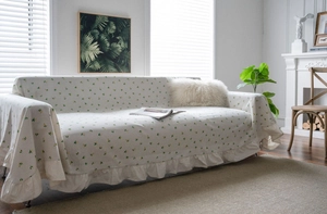 Detail of lemon pattern sofa cover with elegant ruffled edges and floral textile texture