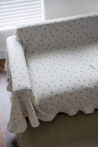 Close-up of lemon print sofa cover featuring elegant ruffled edges on soft cotton fabric