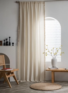 Close-up of waffle textured cream curtains featuring elegant side fringe detailing