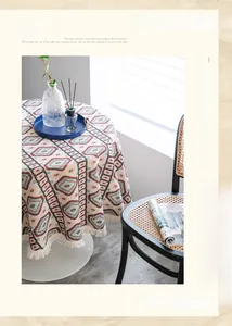 Detail of bohemian geometric table cloth with delicate fringe edges on a round table