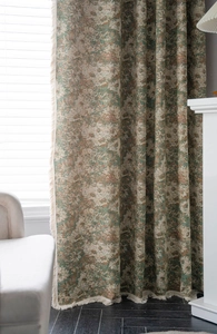 Detailed close-up of green floral jacquard curtain with elegant tassel fringe edge