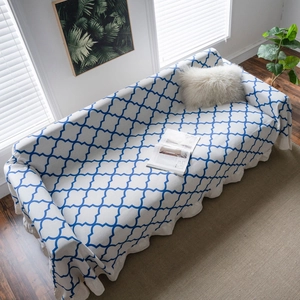 Moroccan geometric blue printed sofa cover with ruffled edge on minimalist couch