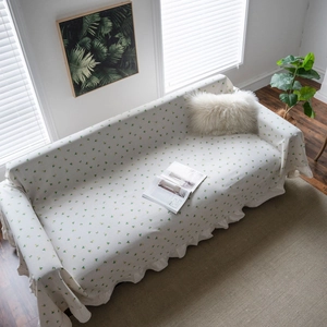 Floral lemon print sofa cover with ruffle edges in a cozy bright living room