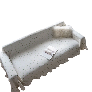 Floral lemon print sofa cover with ruffle edges on white background with pillows