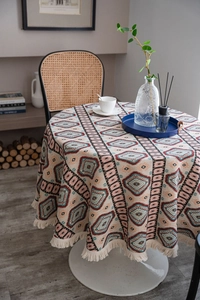 Close-up of bohemian round tablecloth with geometric patterns and fringe edges
