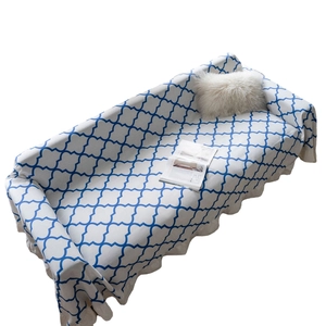 Blue clover geometric sofa cover with ruffle trim and textured fabric on white background