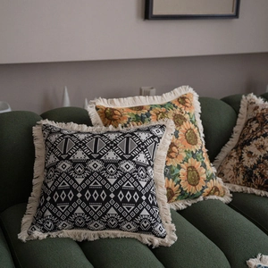 Ethnic geometric and sunflower jacquard throw pillow with decorative fringe on a sofa