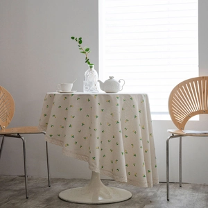 Round floral tablecloth with lemon print and delicate lace trim in French country style